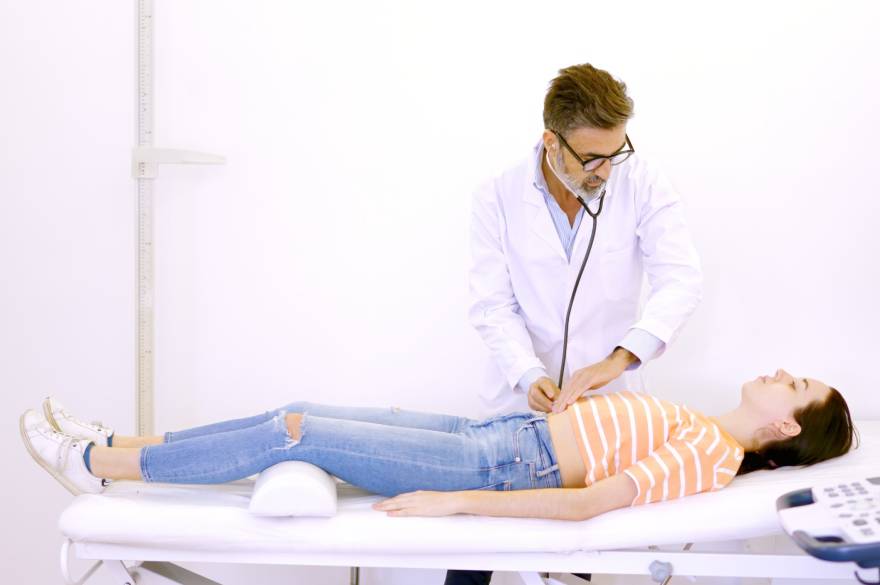 Doktor pregledava devojku stetoskopom
