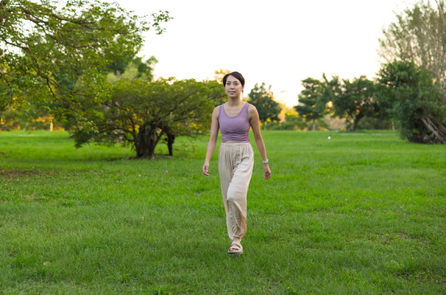 Žena hoda kroz park